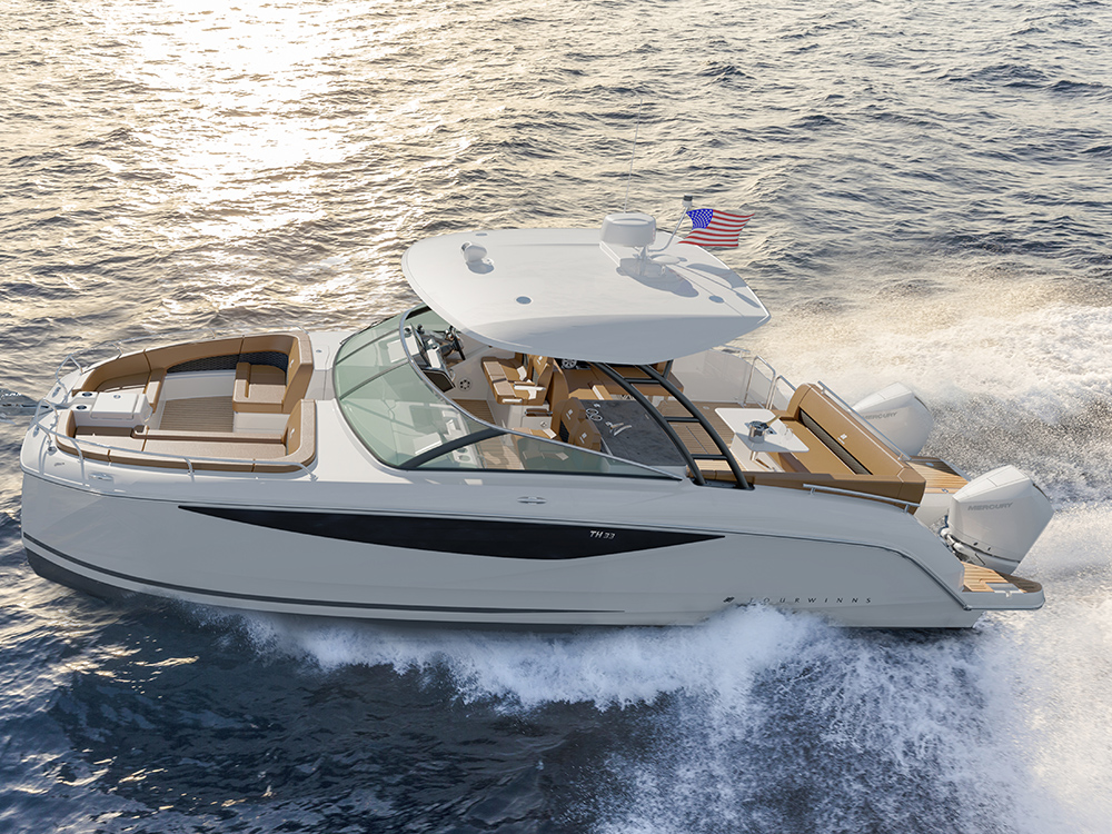 Four Winns TH33 power catamaran cruising at speed.