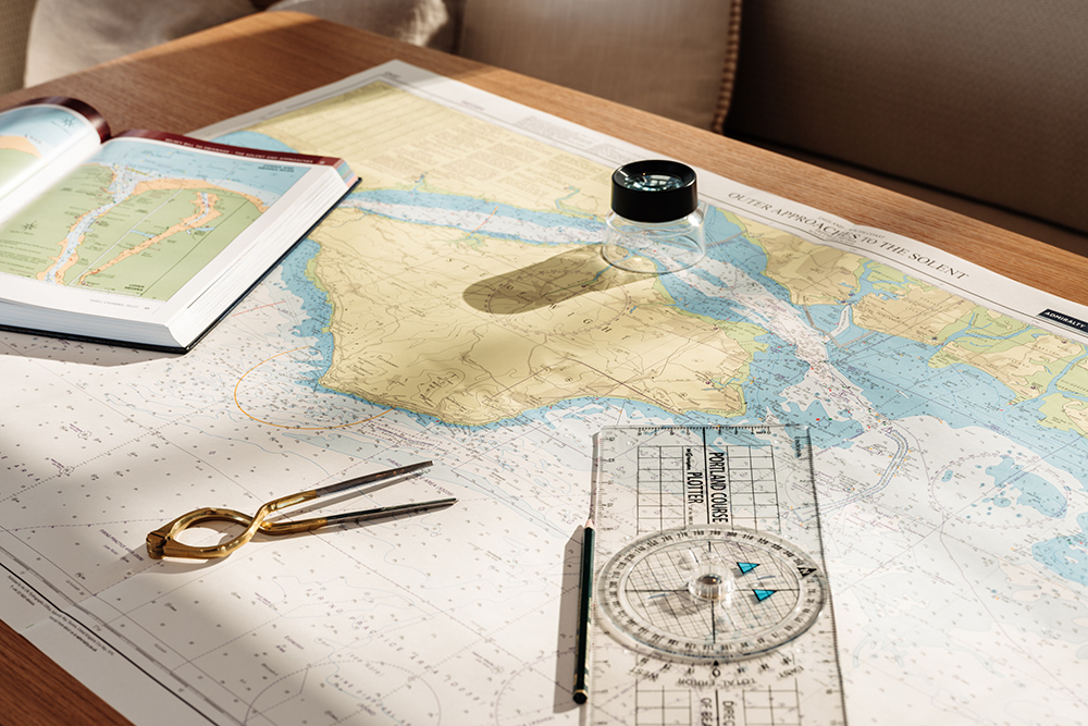 Chart table with admiralty charts laid out