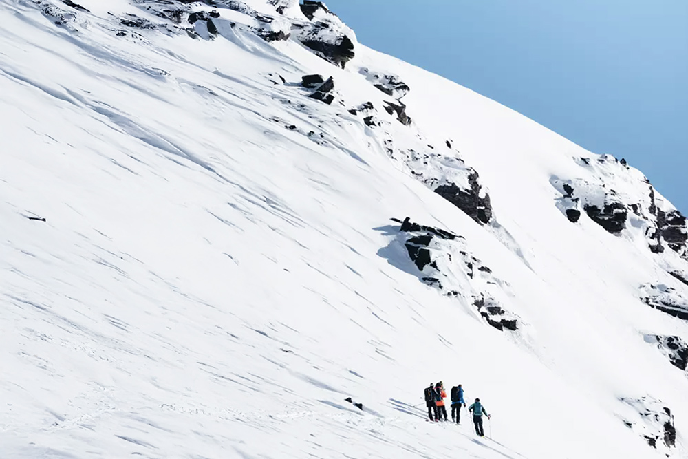 4 skiers on a mountain