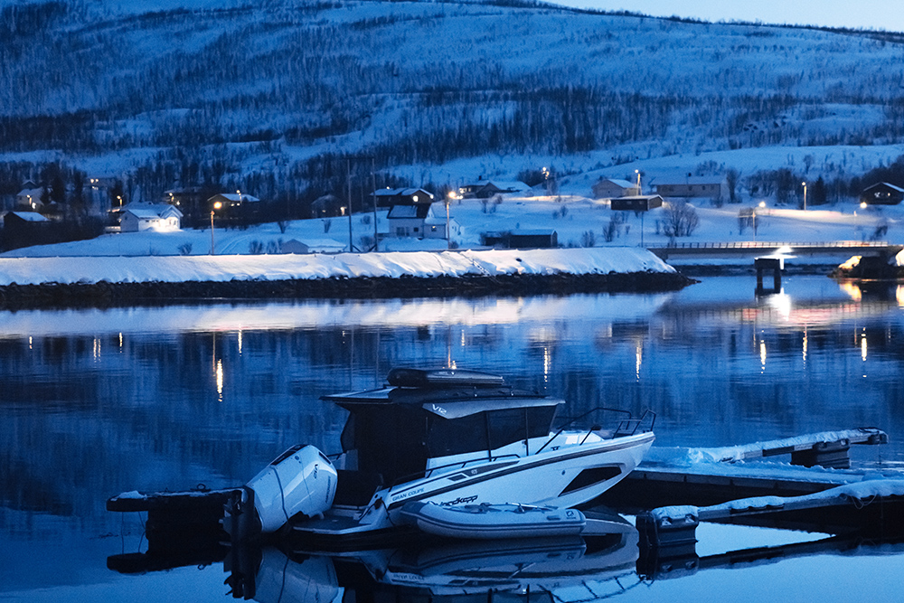 Dark night harbour with Nordkapp on her pontoon.