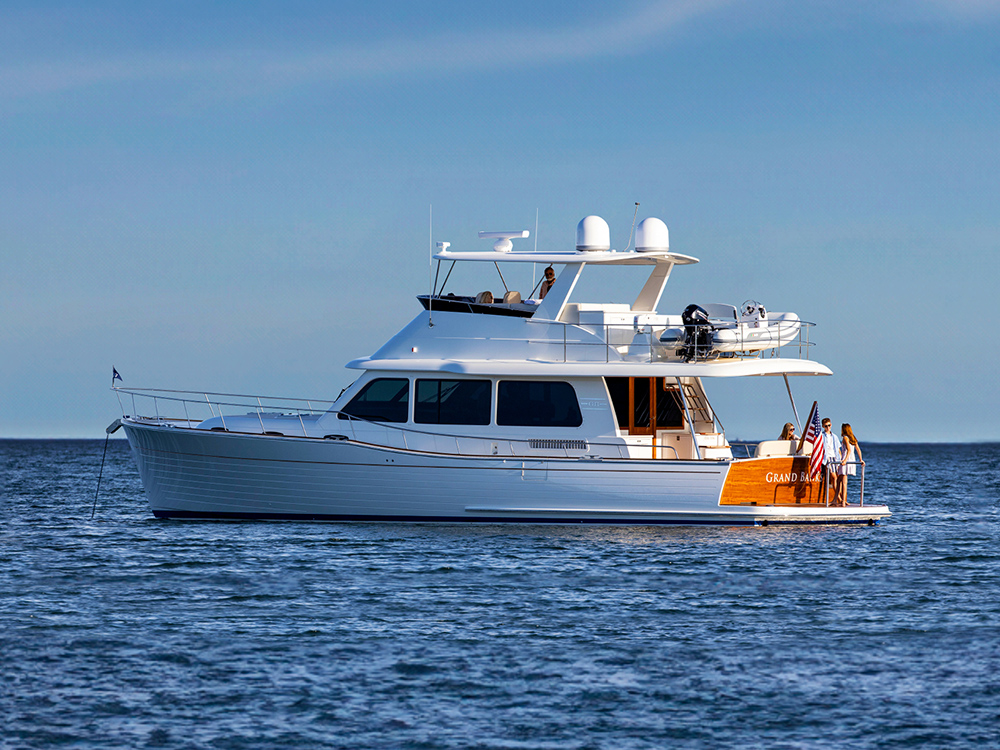 Grand Banks 54 motor yacht with flybridge cruising offshore.