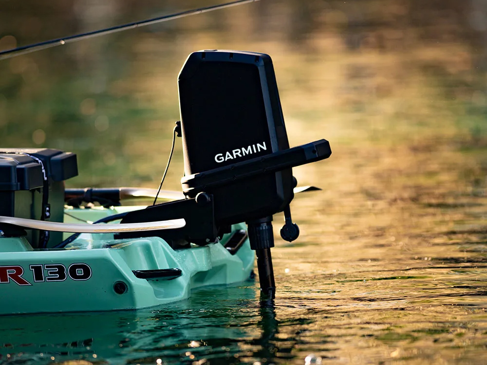Garmin Force Current trolling motor mounted on a fishing kayak in calm water.