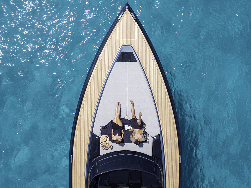 Couple relaxing on the bow sunpad of SAY 52 carbon yacht.