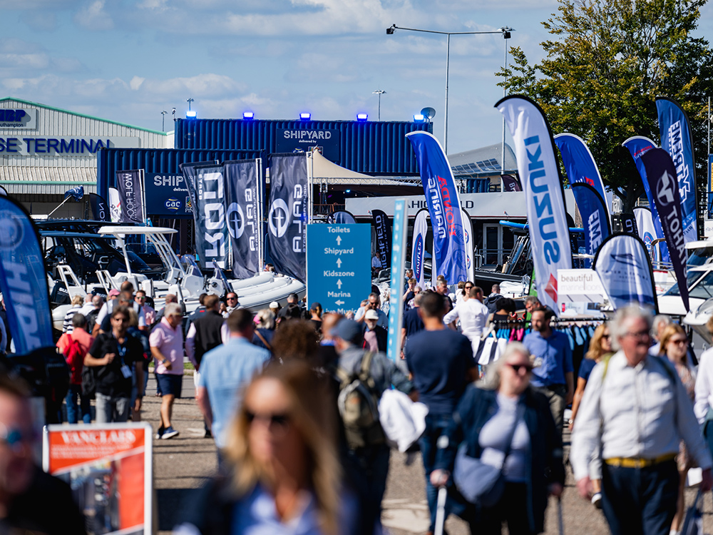 Crowds exploring boats and marine equipment at Southampton International Boat Show.