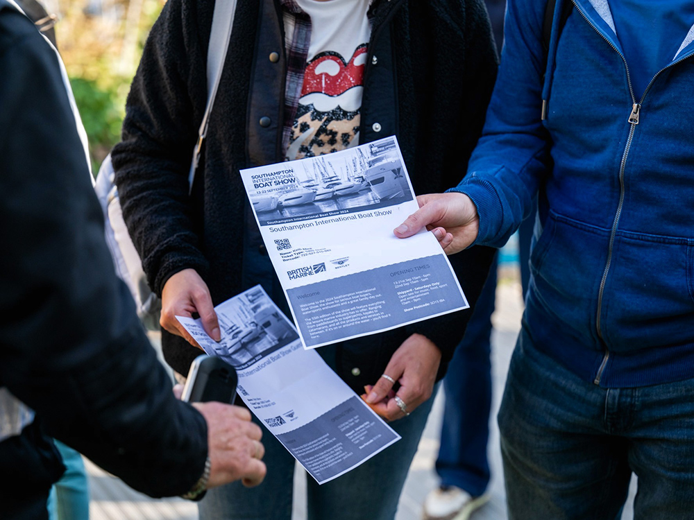 Visitors holding Southampton International Boat Show tickets while preparing to enter the event.