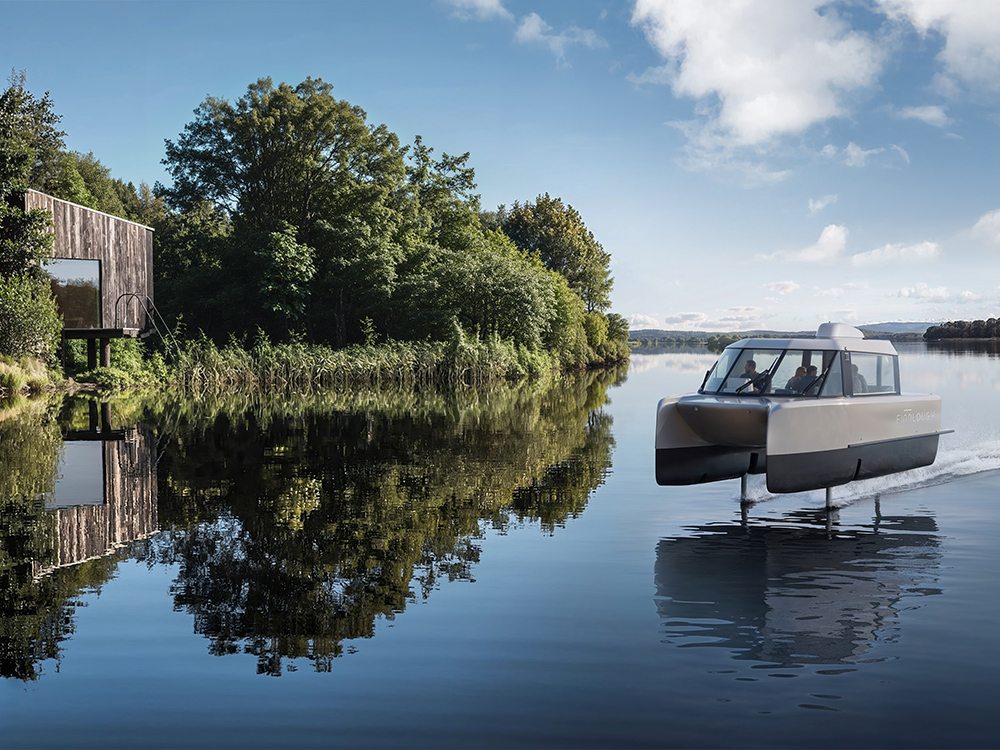 Electric hydrofoiling catamaran Vessev VS–9 glides on Lower Lough Erne beside Finn Lough eco resort woodland cabins.