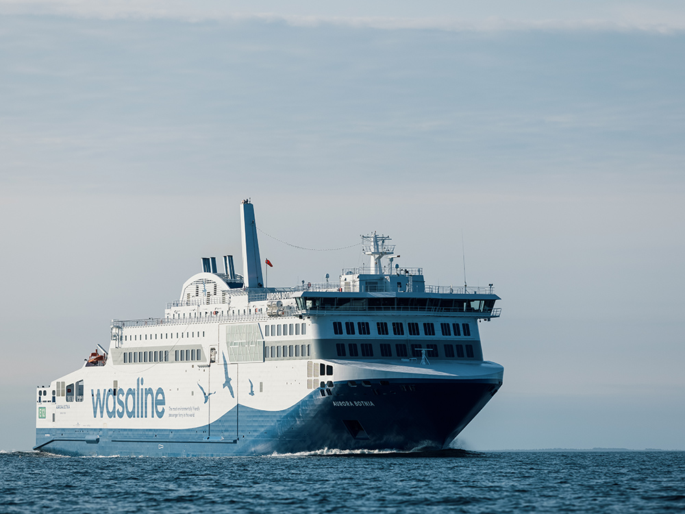 Ferry sailing at sea with Wasaline branding, showcasing sustainable hybrid propulsion technology.