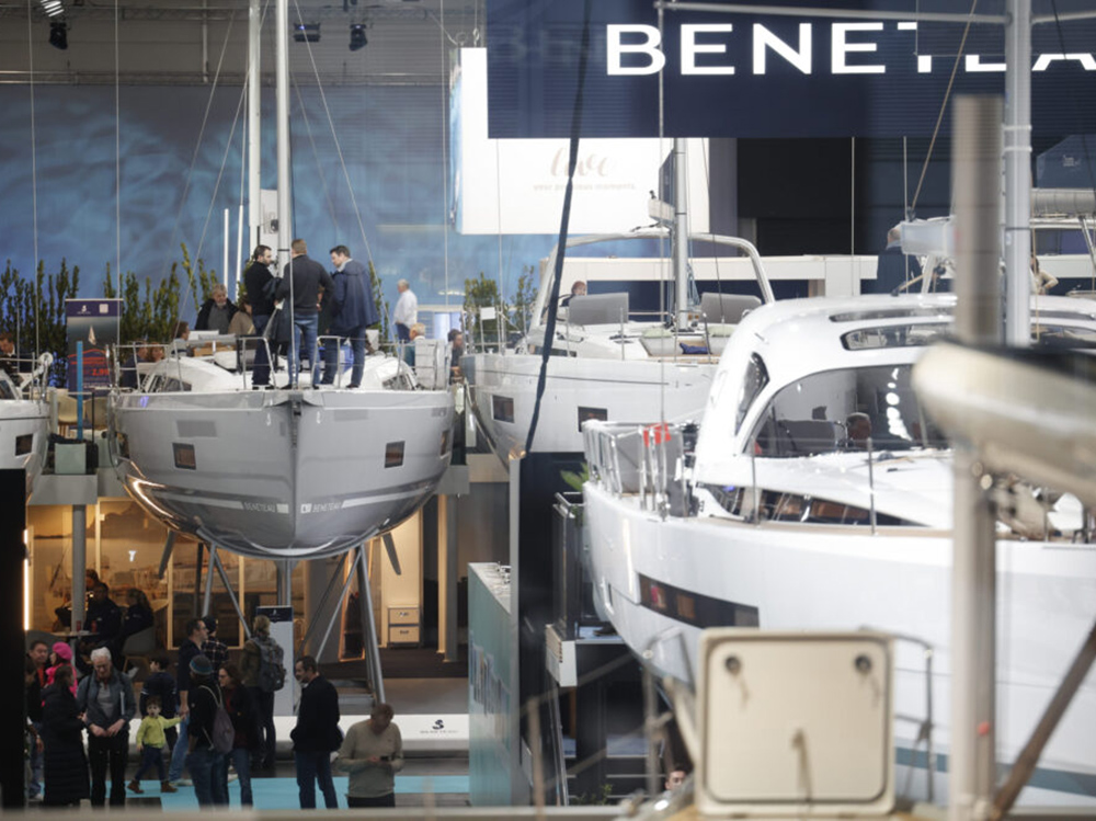 Visitors explore yachts and motorboats on display at the Beneteau stand during boot Düsseldorf boat show.