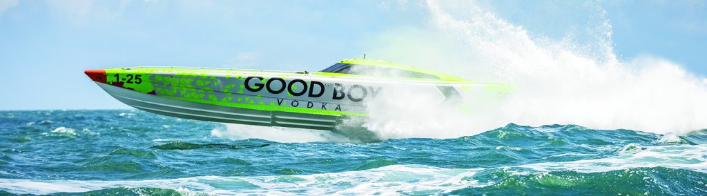 green powerboat Good Boy Vodka racing to the left with white spray behind