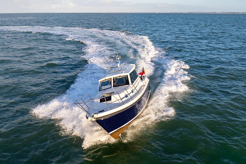 Orkney Pilothouse 27 driving towards camera on blue sea