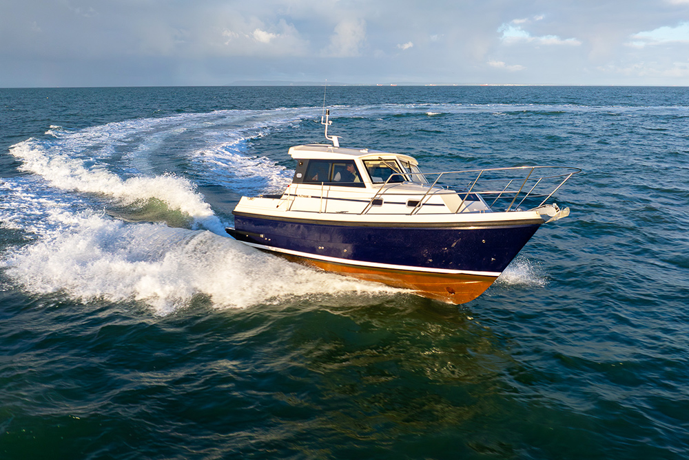 The Orkney Pilothouse 27 powering from left to right on a dark blue sea