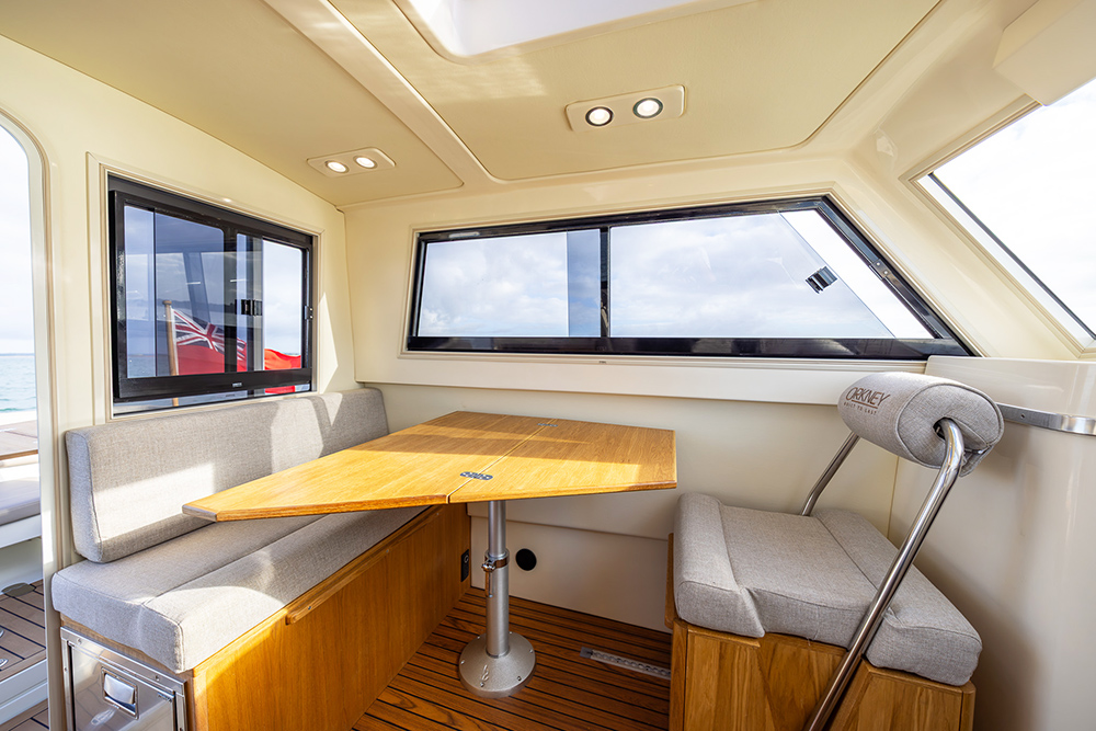 Orkney Pilothouse 27 dining area with grey upholstery and light wood table