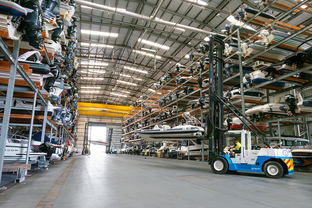 Dry stack shelves with hundreds of boats stacked inside a big building