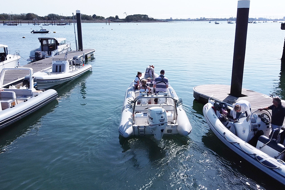 RIB with family onboard leaving a pontoon heading out to sea