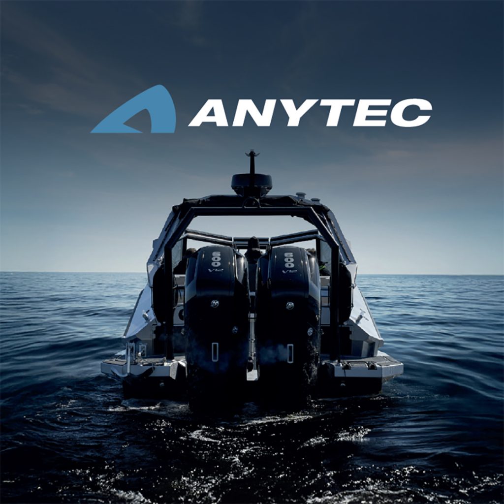 Twin Mercury V8 outboards power an Anytec aluminium boat across calm open water under a dramatic sky.