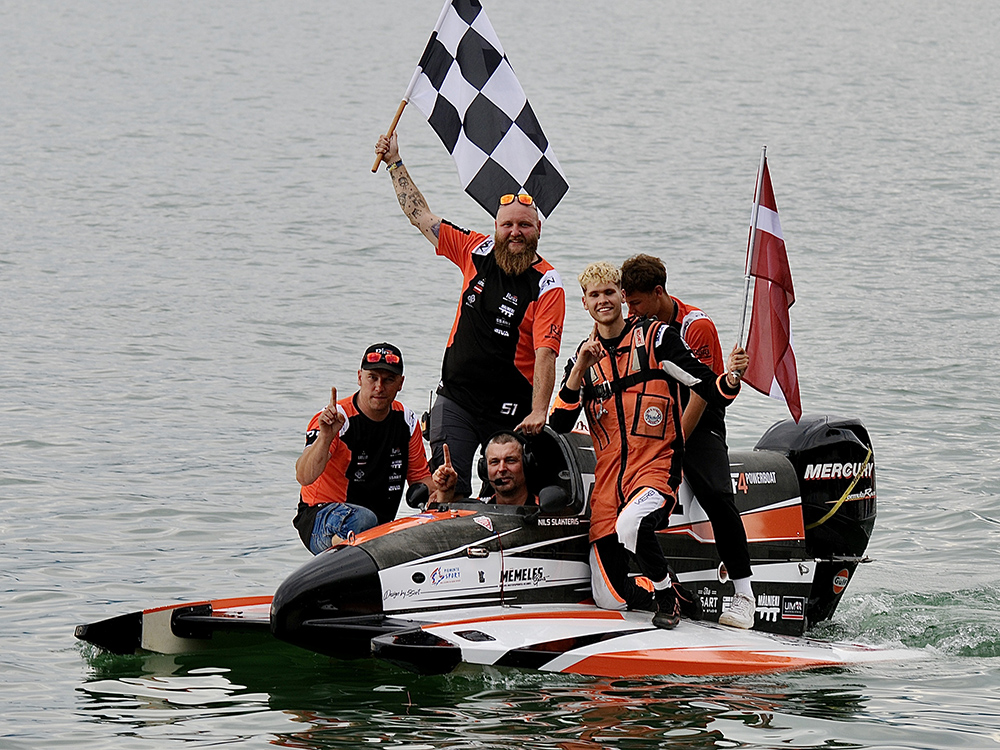 Nils Slakteris and his RIGA Powerboat Racing Team celebrate on their Mercury-powered F4 boat at Lake Viverone after winning the 2025 UIM F4 World Championship.