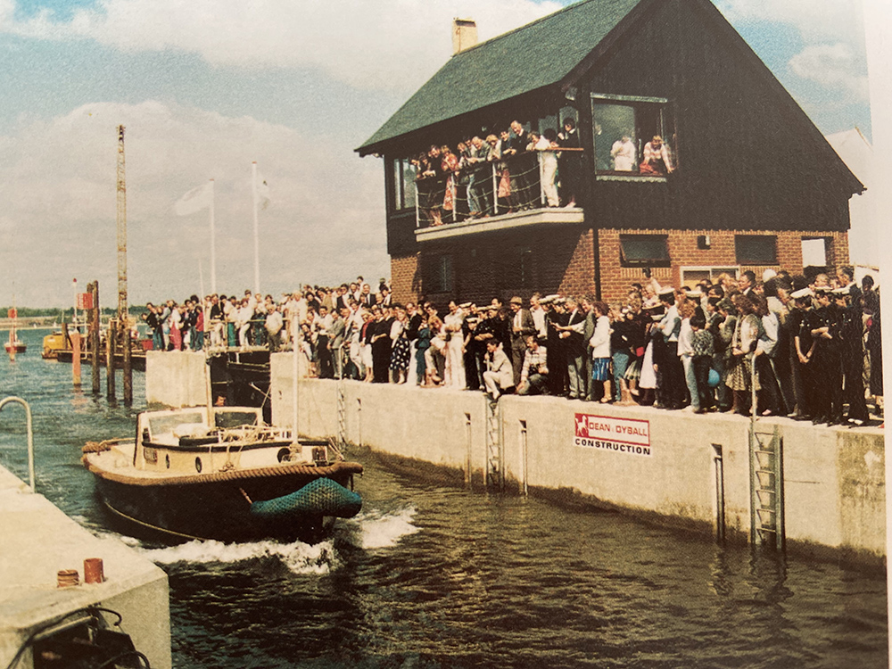 Crowds watch boats pass through Hythe Marina Village lock during its 1985 opening.