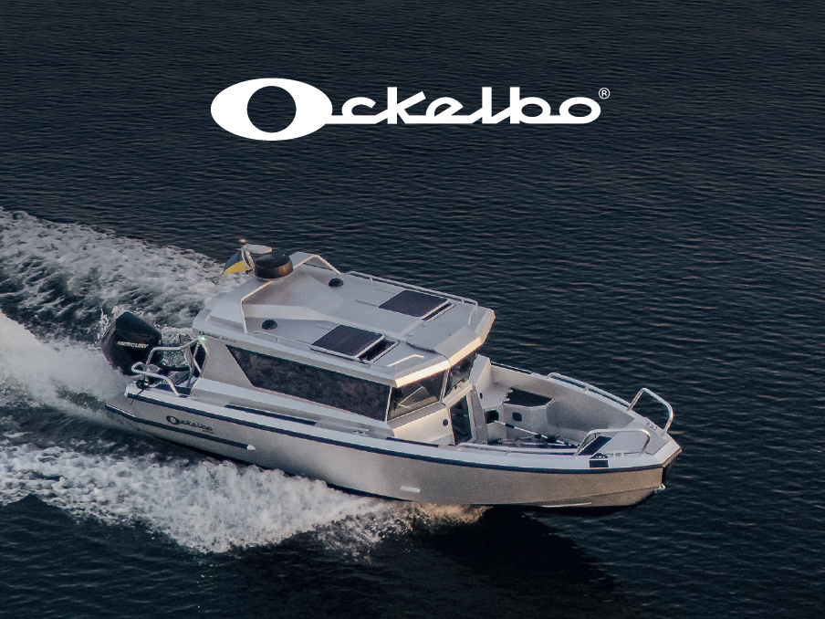 Ockelbo aluminium cabin boat powered by a Mercury outboard cruises across calm water.