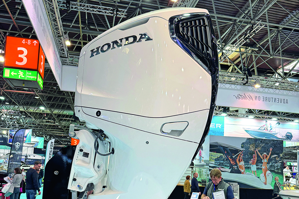 Honda BF300 outboard on its stand at Boot Dusseldorf boat show in 2025 with show scenes behind