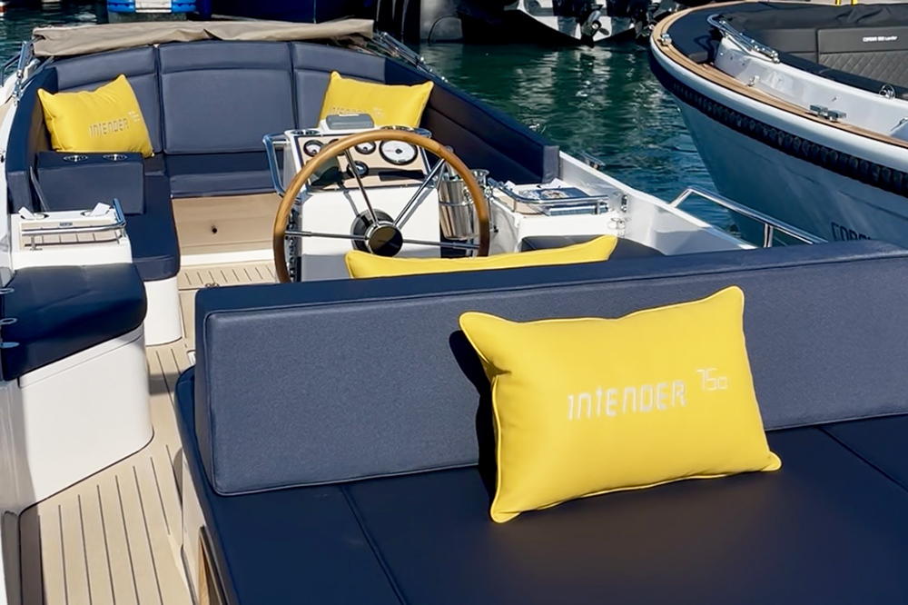 Dark blue upholstery to Interboat 750 with bright yellow cushions featuring the name Interboat
