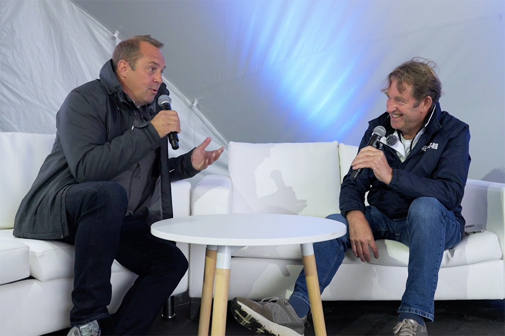 Paul McCarthy and Hugo Montgomery-Swan sat on sofas talking during an interview recording