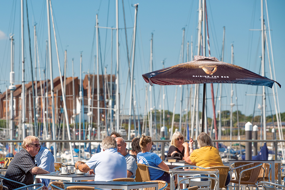 group of people eating and drinking at marina side cafe