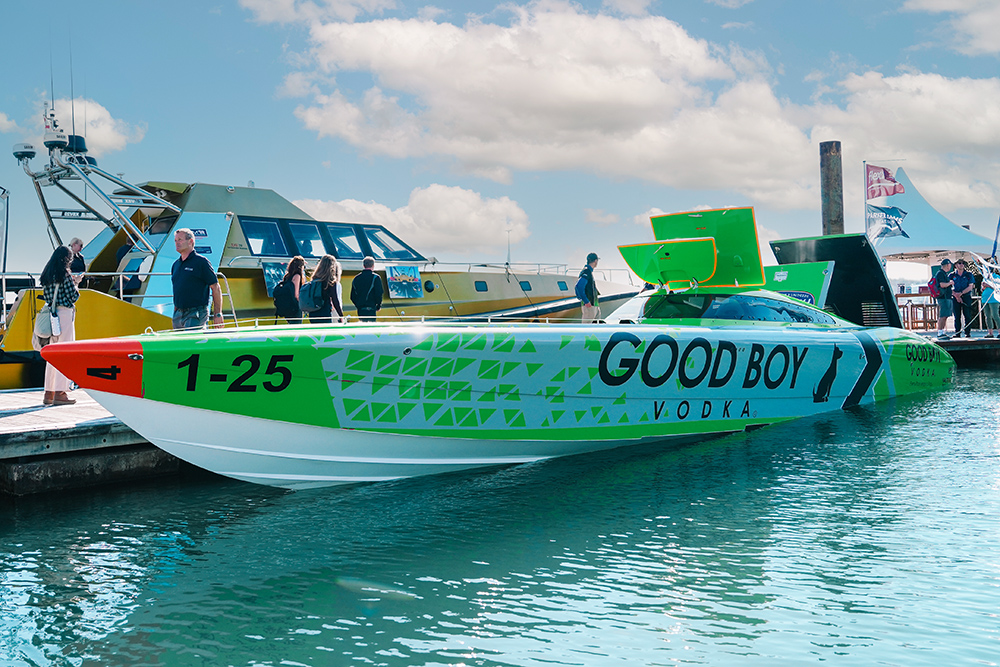 green and white raceboat , Good Boy Vodka made fast on show pontoon