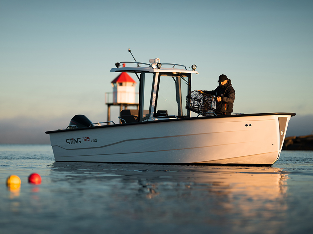 Sting 725 Pro T-Top boat showcased at sunrise near a lighthouse.
