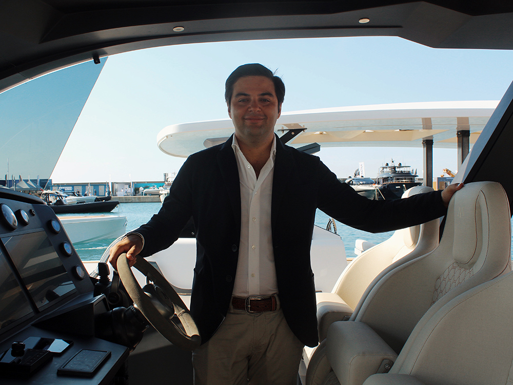 Marc Forne at the helm of the Maxim Yachts' Max 44 R during the Fort Lauderdale Boat Show, surrounded by luxury yachts in harbour.