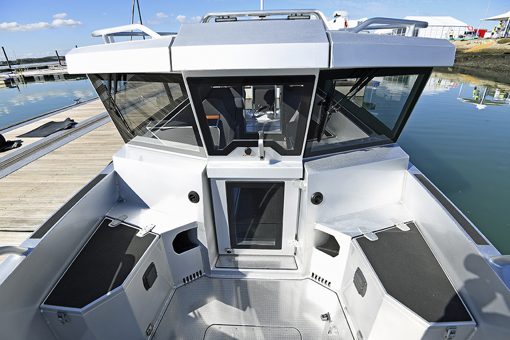 Ockelbo B25 CAB with forward cockpit seating, sturdy grab rails and clear access door to cabin at dockside.