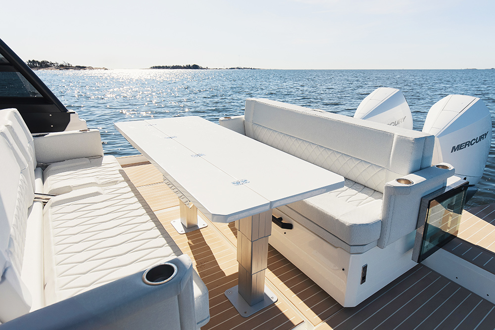 Aft dining area with two bench seats and good sized long table in the middle