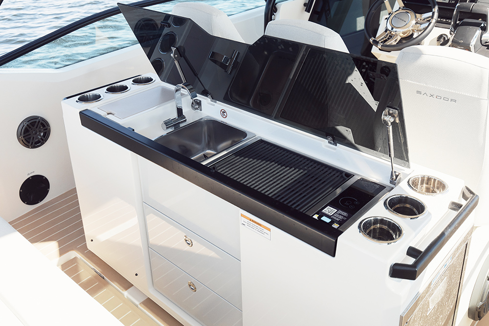 Lid up to the wet bar with sink and griddle on the Saxdor 320 GTO