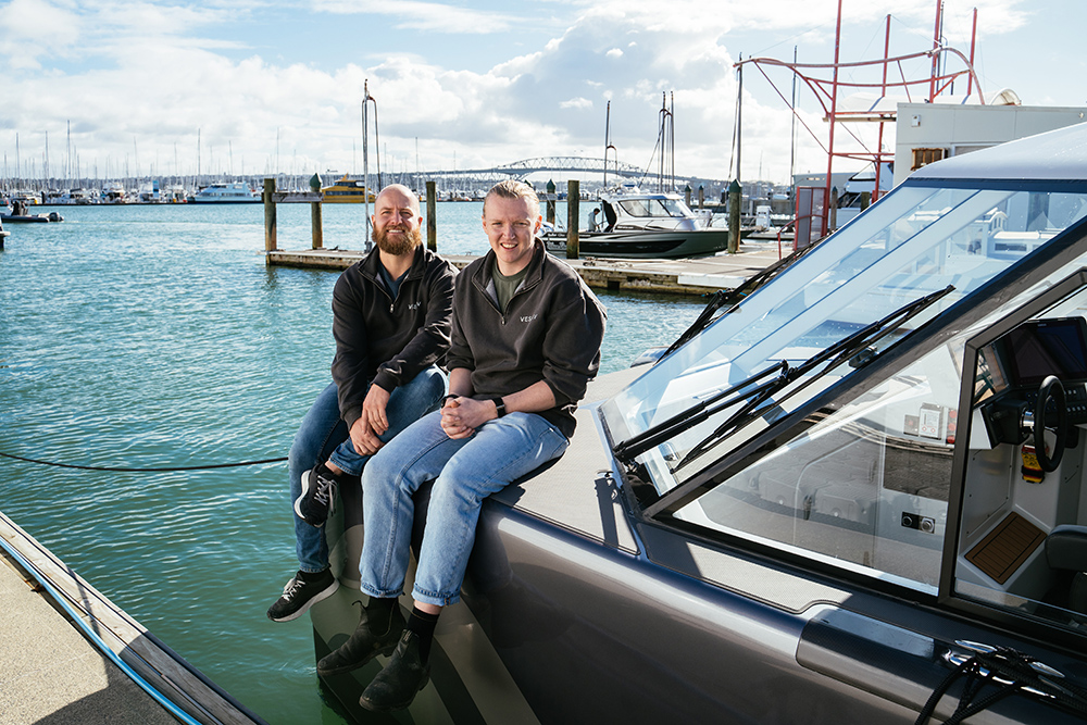 Two men sat on boat bow. Caption reads Vessev co-founders, CEO Eric Laakmann, left, and CTO Max Olson.
