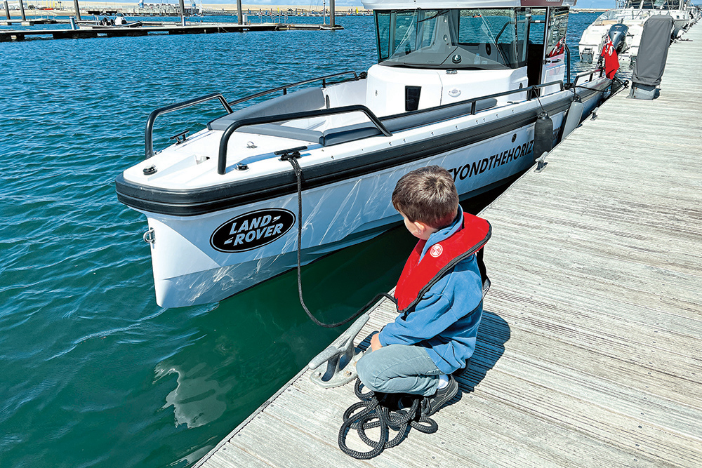 boy on pontoons typing ropes