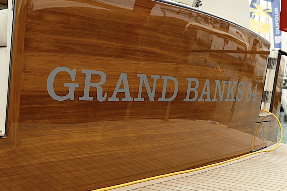 View of the polished wood stern with the wording signwritten on saying Grand Banks 54