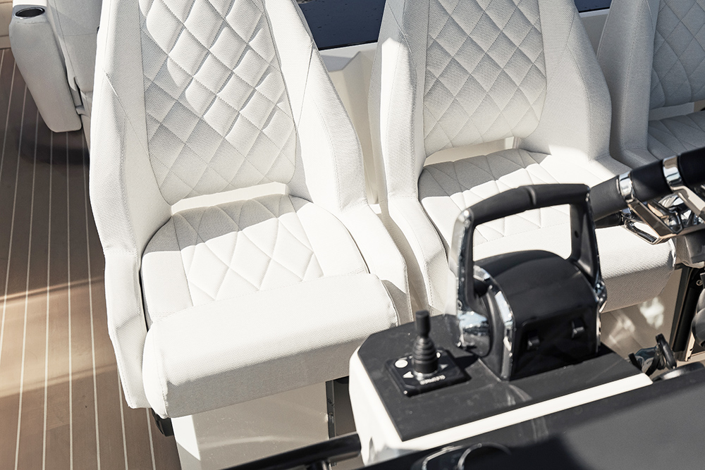 Saxdor 320GTO helm and navigators seats in white upholstery with throttle control in view
