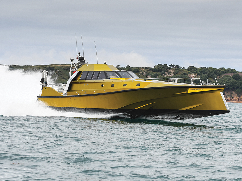 Thunder Child II running fast offshore, with spray trailing.