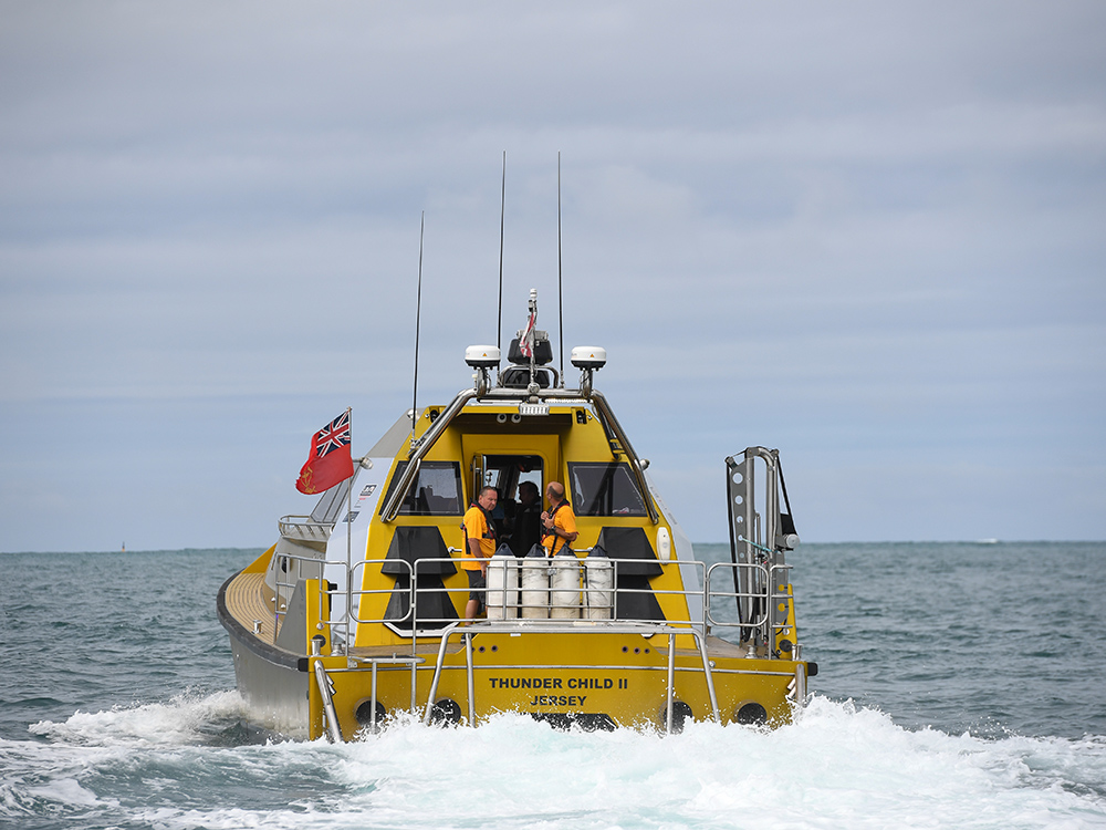 Thunder Child II seen from astern underway, with crew on deck.