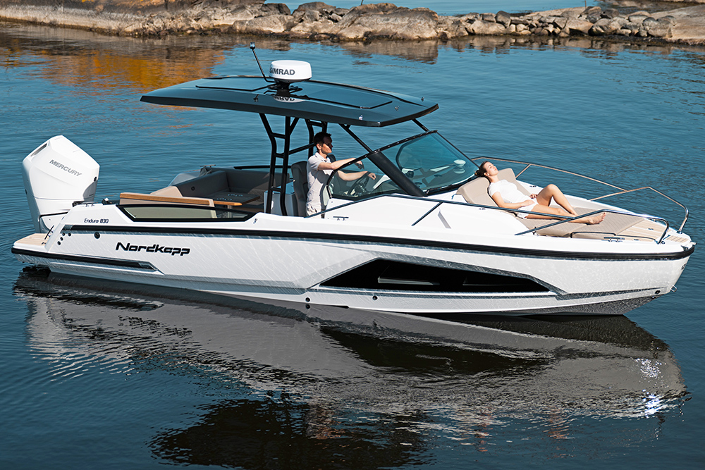 Nordkapp Enduro 830 T-Top version with man driving and girl relaxing on bow sun lounger