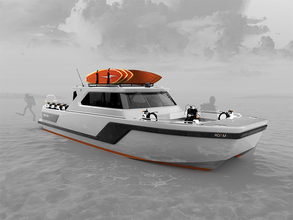 ROAM C12 dive catamaran underway with dive racks, tanks and gear on deck, plus kayaks stowed on the cabin roof.