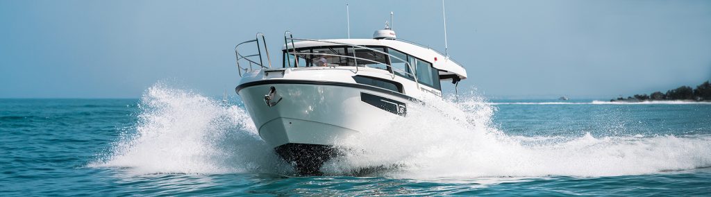 Viknes 10 powers through a blue sea with white spray coming off the hull on both sides