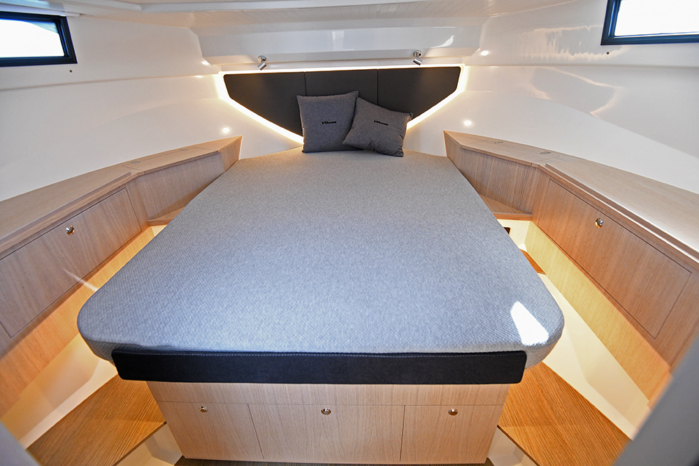 Master bedroom in Viknes 10 with double central bed and walkways all around and two grey cushions
