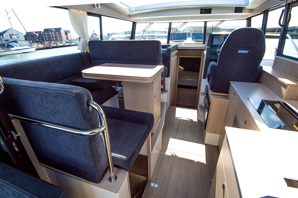 Wheelhouse saloon to Viknes 10 with dark blue upholstery and light wood finish to fittings