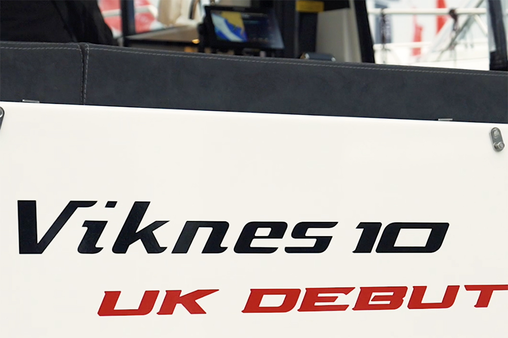 Stern of Viknes 10 with wording sticker saying Viknes 10 in black text and UK Debut in red text
