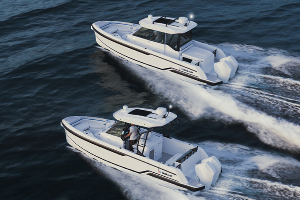 Drone view of two Wellcraft 28 boats making way with white spray on a dark sea