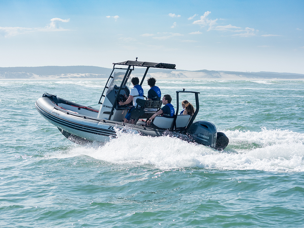 RIB powered by a Yamaha outboard cruising at speed with passengers aboard in open coastal waters.