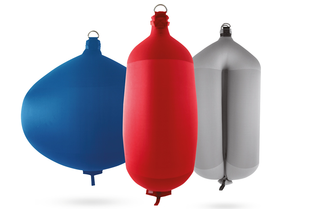 Inflatable fenders in a row in blue, red and grey colours