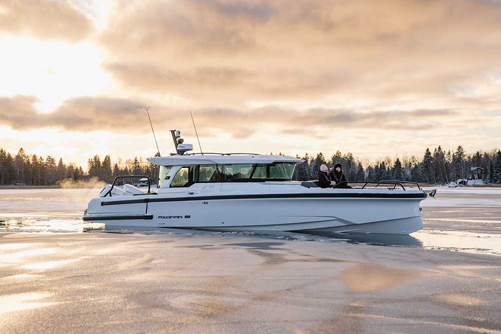 Axopar 38 XC Cross Cabin on icy winter waters, highlighting enclosed wheelhouse, cold-weather capability and year-round adventure boating.