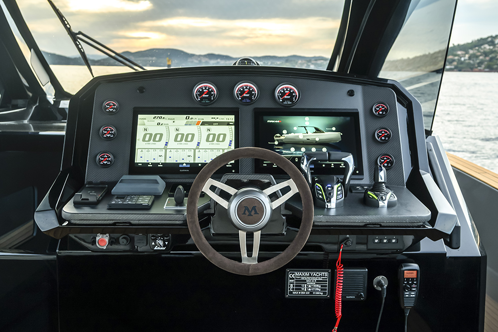 Helm console of the Maxim Yachts Max 44R with twin Garmin displays, analogue gauges and performance-focused controls.