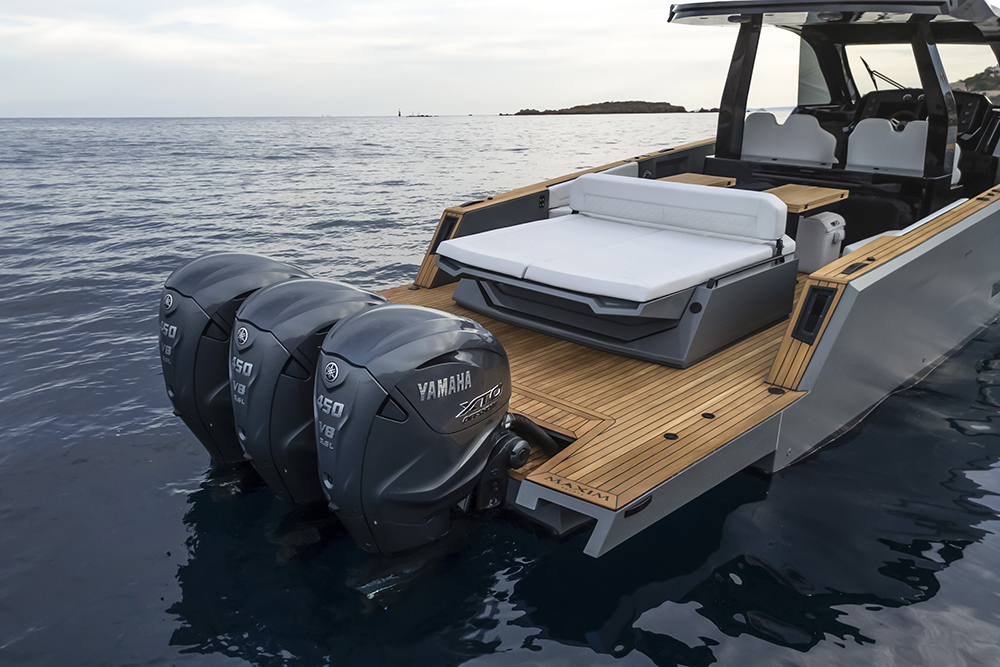 Aft deck of the Maxim Yachts Max 44R with teak bathing platform, sunbed and triple Yamaha XTO outboards.